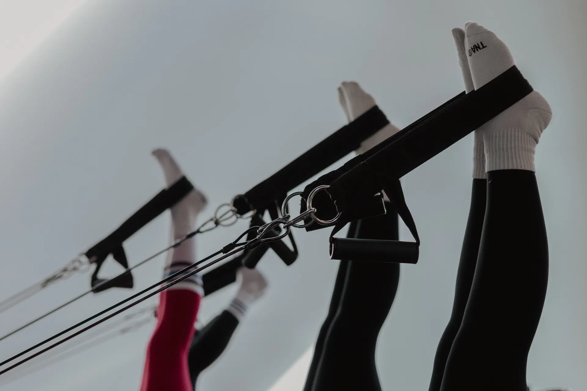 Feet in straps during Pilates at STRONG Kelowna
